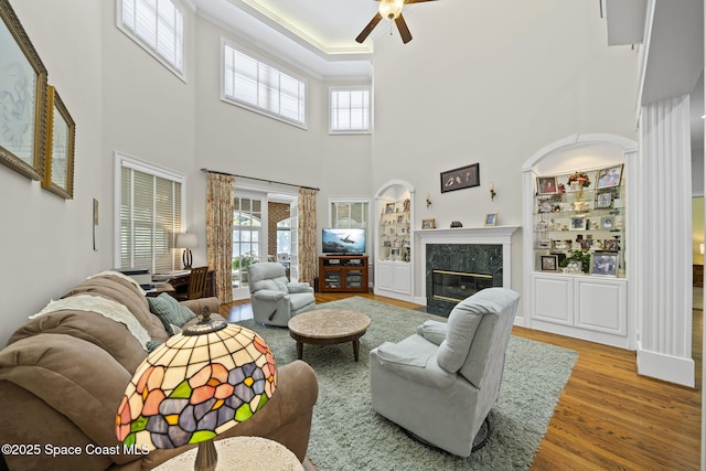 1407 Rockledge Dr, Rockledge, FL 32955 - living area featuring wood finished floors, a ceiling fan, plenty of natural light, a high end fireplace, and a towering ceiling