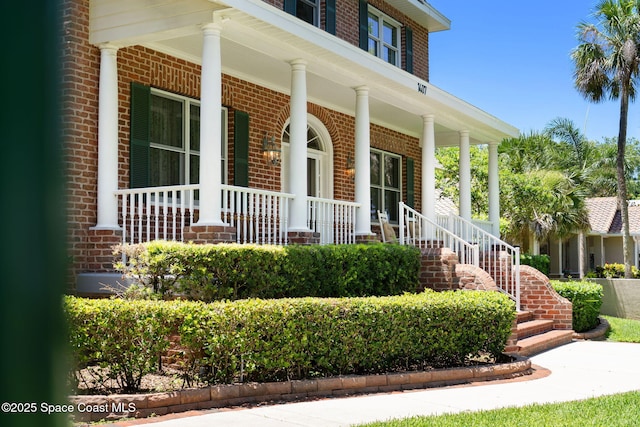 1407 Rockledge Dr, Rockledge, FL 32955 - doorway to property with brick siding and a porch