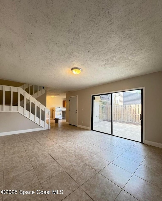 1917 Vista Oaks Cir NE, Palm Bay, FL 32905 - unfurnished living room with a textured ceiling, tile patterned floors, and stairs