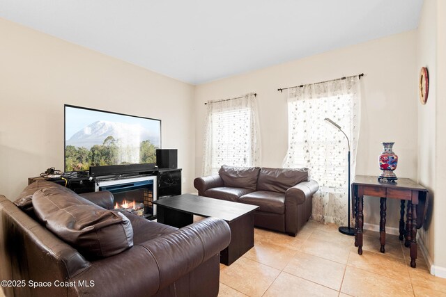 980 Dillard Dr SE, Palm Bay, FL 32909 - living area with light tile patterned floors and a lit fireplace