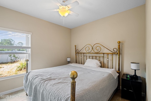 980 Dillard Dr SE, Palm Bay, FL 32909 - tiled bedroom with baseboards and a ceiling fan
