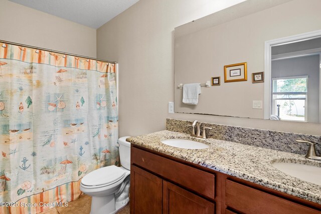 980 Dillard Dr SE, Palm Bay, FL 32909 - bathroom featuring double vanity, tile patterned floors, and curtained shower