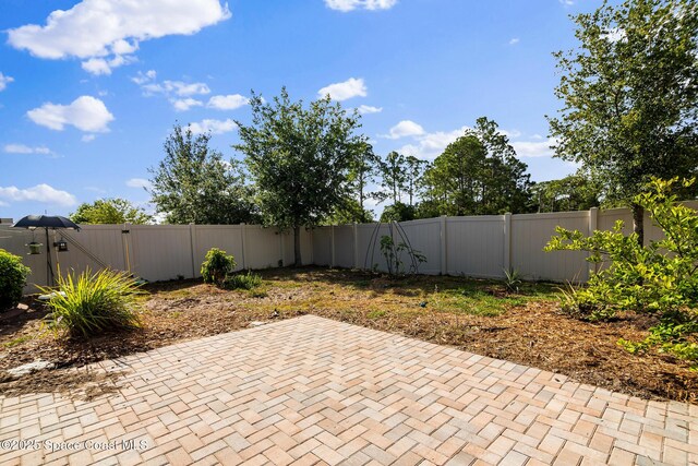 980 Dillard Dr SE, Palm Bay, FL 32909 - fenced backyard with a patio area