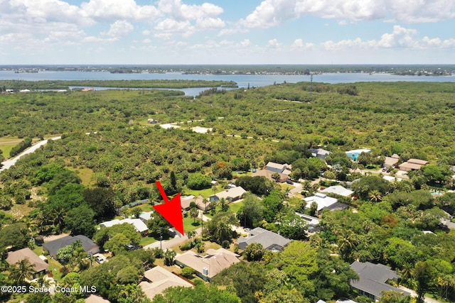 112 Carmen St, Melbourne Beach, FL 32951 - aerial view of residential area with a nearby body of water and a heavily wooded area