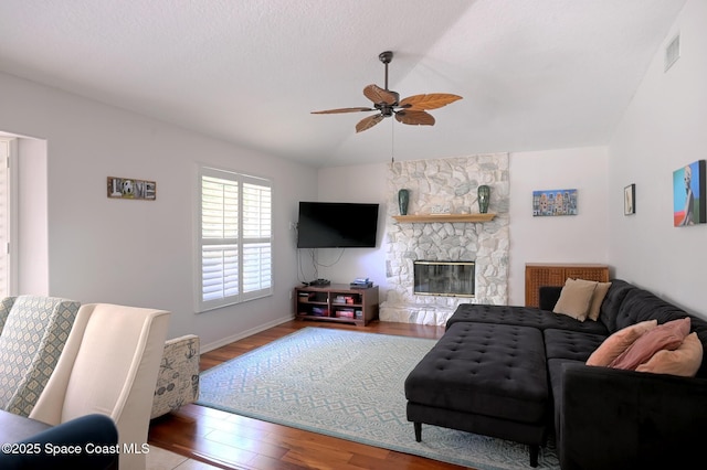 112 Carmen St, Melbourne Beach, FL 32951 - living area featuring ceiling fan, wood finished floors, vaulted ceiling, and a stone fireplace