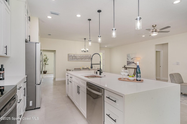 942 Toluca St SE Unit 1, Palm Bay, FL 32909 - kitchen with appliances with stainless steel finishes, ceiling fan, white cabinets, a kitchen island with sink, and recessed lighting