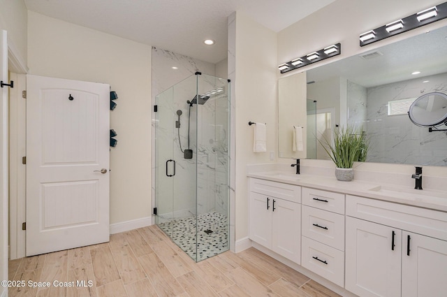 942 Toluca St SE Unit 1, Palm Bay, FL 32909 - bathroom with a marble finish shower, double vanity, wood finished floors, and recessed lighting