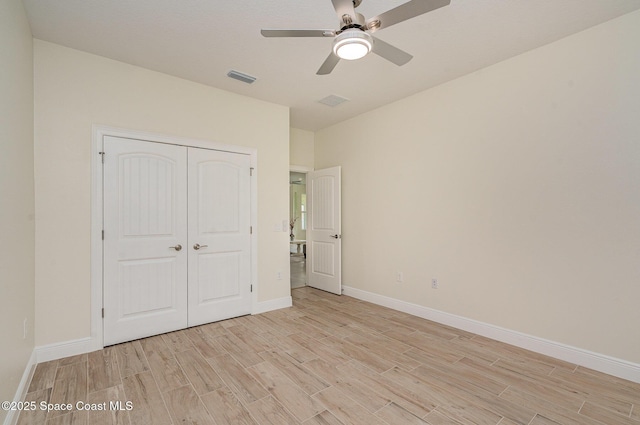 942 Toluca St SE Unit 1, Palm Bay, FL 32909 - unfurnished bedroom featuring light wood-type flooring, a closet, and ceiling fan