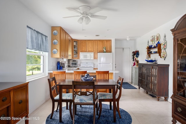 61 Woodland Dr Unit 201, Vero Beach, FL 32962 - dining space featuring ceiling fan and light tile patterned flooring