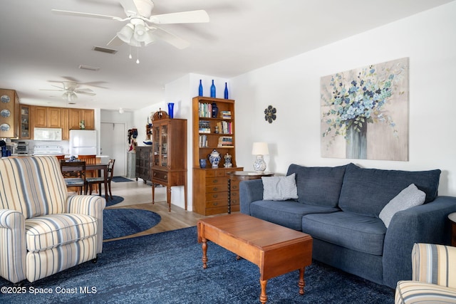 61 Woodland Dr Unit 201, Vero Beach, FL 32962 - living area featuring a ceiling fan and light wood-type flooring