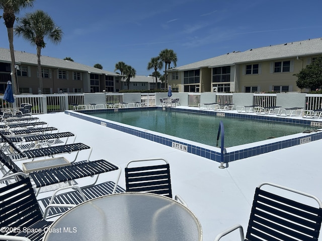 951 Sonesta Ave NE Unit 204, Palm Bay, FL 32905 - community pool with a patio area and outdoor dining area