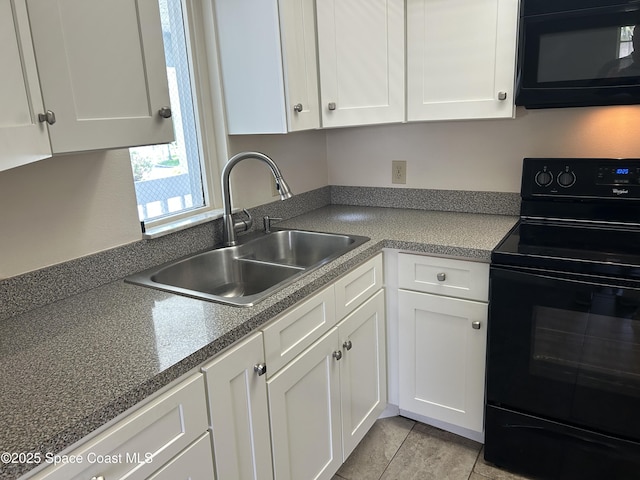 951 Sonesta Ave NE Unit 204, Palm Bay, FL 32905 - kitchen with black appliances, white cabinetry, and light tile patterned flooring