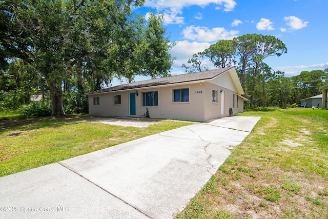 1421 Degroodt Rd SW, Palm Bay, FL 32908 - ranch-style home featuring driveway, a front lawn, and stucco siding