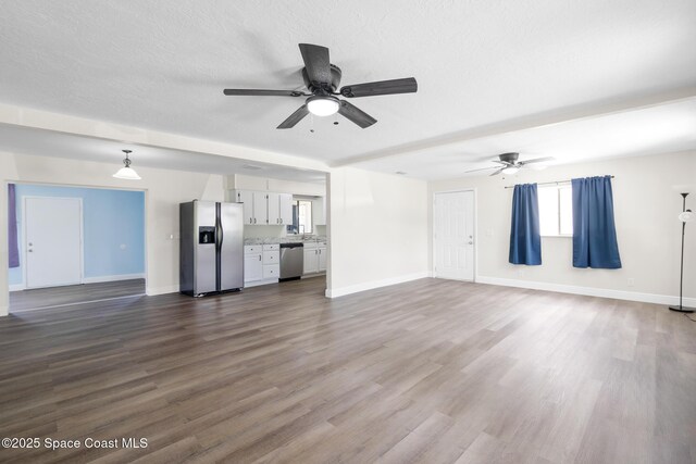 1421 Degroodt Rd SW, Palm Bay, FL 32908 - unfurnished living room featuring a ceiling fan and dark wood finished floors