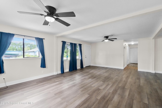 1421 Degroodt Rd SW, Palm Bay, FL 32908 - unfurnished living room featuring ceiling fan, plenty of natural light, and wood finished floors