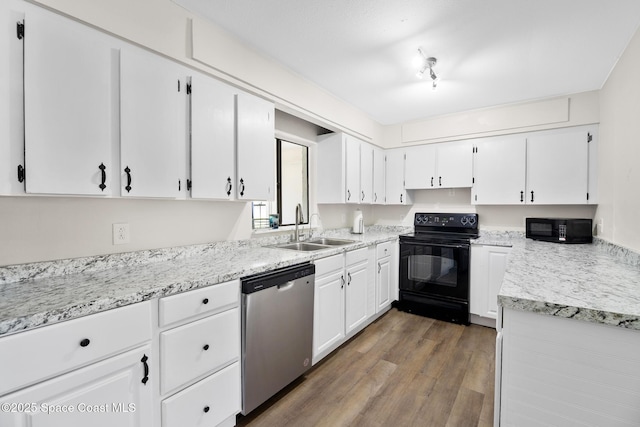 1421 Degroodt Rd SW, Palm Bay, FL 32908 - kitchen featuring black appliances, white cabinetry, and wood finished floors