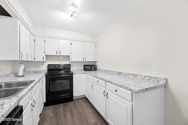 1421 Degroodt Rd SW, Palm Bay, FL 32908 - kitchen featuring black appliances, white cabinets, dark wood finished floors, and light countertops
