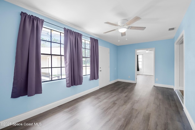 1421 Degroodt Rd SW, Palm Bay, FL 32908 - unfurnished room with ceiling fan, wood finished floors, and healthy amount of natural light