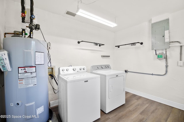 1421 Degroodt Rd SW, Palm Bay, FL 32908 - laundry area with water heater, electric panel, washing machine and clothes dryer, and wood finished floors