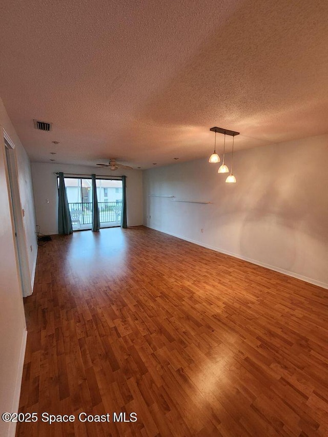 5807 N Atlantic Ave Unit 322, Cape Canaveral, FL 32920 - empty room featuring wood finished floors and a textured ceiling