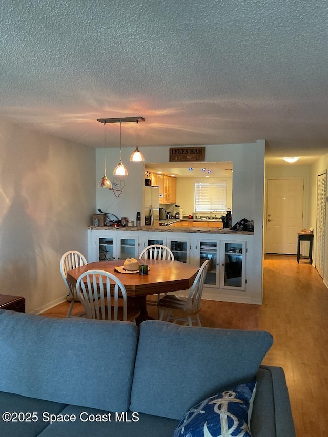5807 N Atlantic Ave Unit 322, Cape Canaveral, FL 32920 - dining space with a textured ceiling and wood finished floors