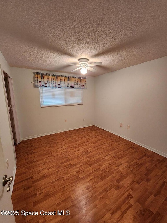 5807 N Atlantic Ave Unit 322, Cape Canaveral, FL 32920 - spare room with a ceiling fan, wood finished floors, and a textured ceiling