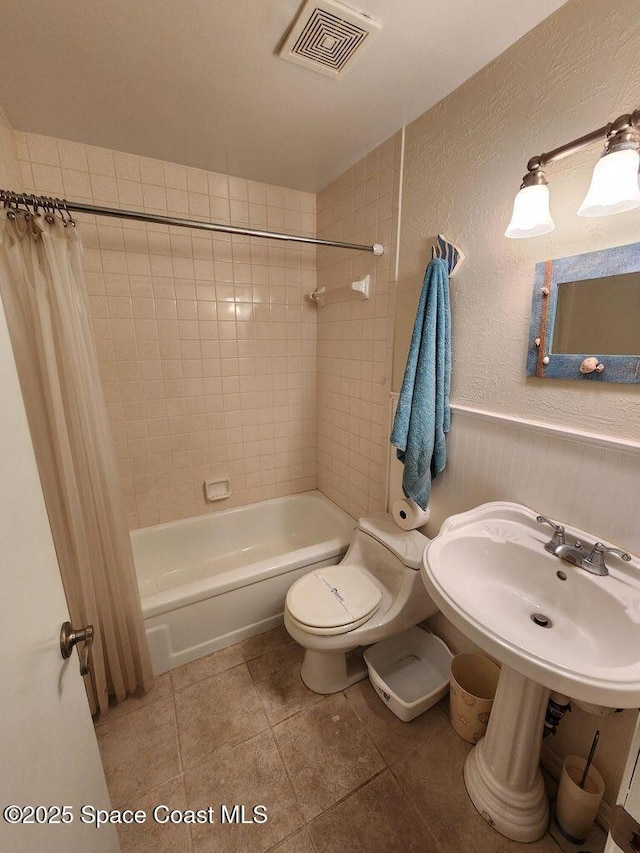 5807 N Atlantic Ave Unit 322, Cape Canaveral, FL 32920 - bathroom featuring shower / bathtub combination with curtain, tile patterned floors, and a textured wall