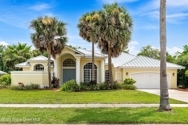 174 Martesia Way, Indian Harbour Beach, FL 32937 - view of front of home with a standing seam roof, stucco siding, an attached garage, concrete driveway, and a metal roof