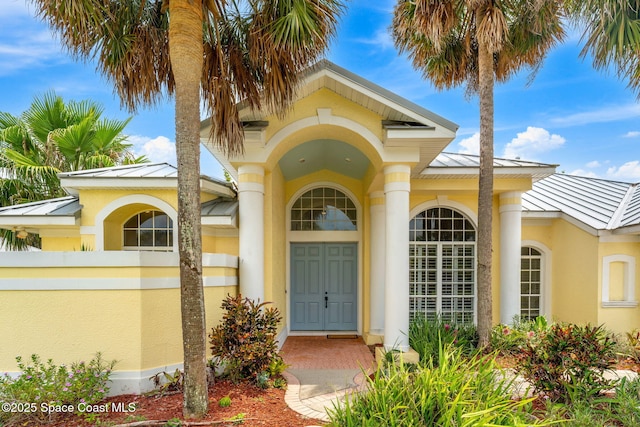 174 Martesia Way, Indian Harbour Beach, FL 32937 - property entrance with a standing seam roof, a metal roof, and stucco siding