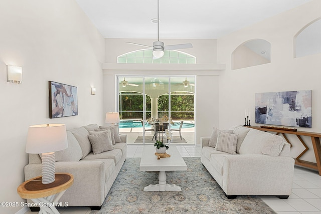 174 Martesia Way, Indian Harbour Beach, FL 32937 - living area featuring tile patterned flooring, a ceiling fan, and a high ceiling