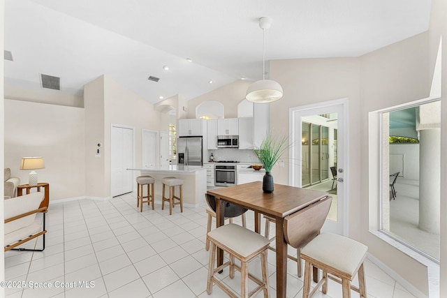 174 Martesia Way, Indian Harbour Beach, FL 32937 - dining space with light tile patterned floors, recessed lighting, and high vaulted ceiling