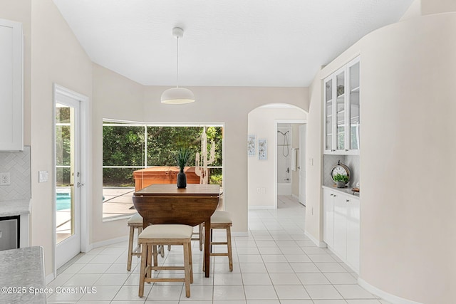 174 Martesia Way, Indian Harbour Beach, FL 32937 - dining room featuring arched walkways, light tile patterned floors, and plenty of natural light