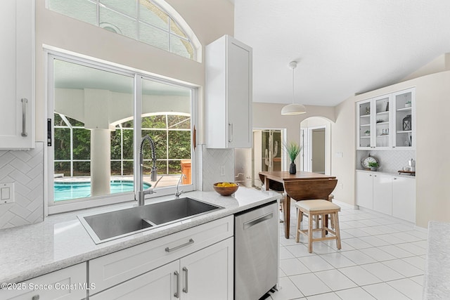 174 Martesia Way, Indian Harbour Beach, FL 32937 - kitchen with stainless steel dishwasher, decorative backsplash, and white cabinetry