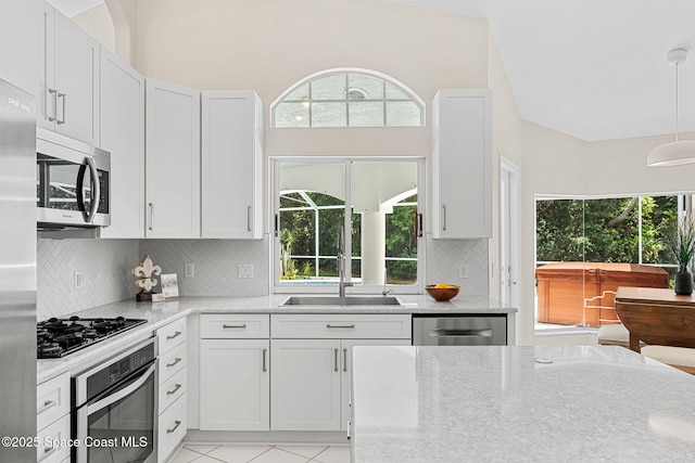 174 Martesia Way, Indian Harbour Beach, FL 32937 - kitchen with appliances with stainless steel finishes, plenty of natural light, tasteful backsplash, and light stone countertops