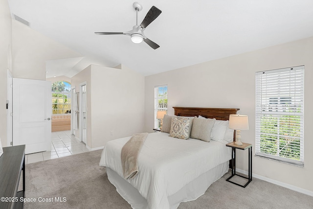 174 Martesia Way, Indian Harbour Beach, FL 32937 - bedroom with light carpet, lofted ceiling, connected bathroom, ceiling fan, and light tile patterned floors