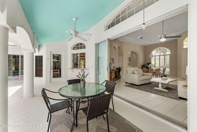 174 Martesia Way, Indian Harbour Beach, FL 32937 - dining room featuring ceiling fan, arched walkways, a high ceiling, and decorative columns