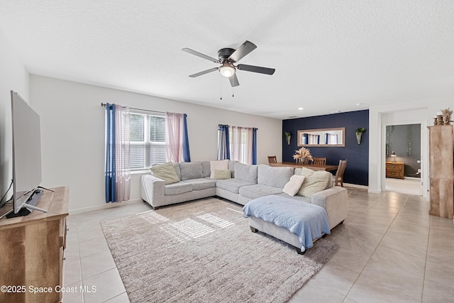 5071 Talbot Blvd, Cocoa, FL 32926 - living room featuring light tile patterned floors, ceiling fan, and a textured ceiling