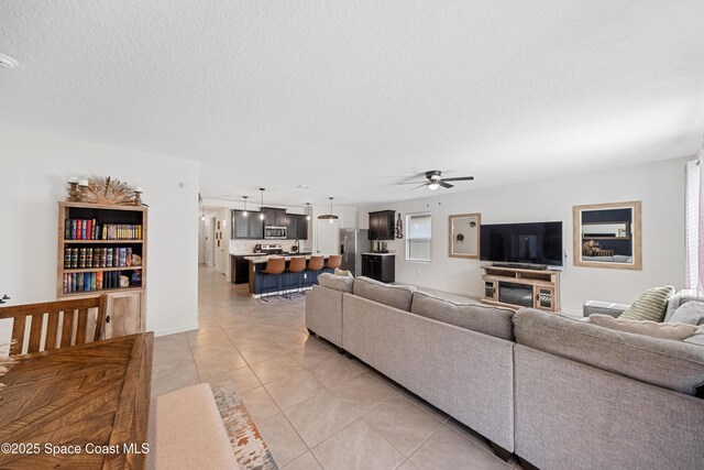 5071 Talbot Blvd, Cocoa, FL 32926 - living area with ceiling fan, light tile patterned floors, and a textured ceiling