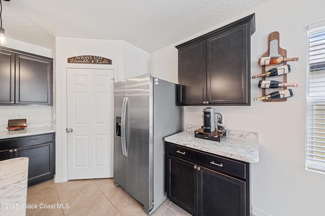 5071 Talbot Blvd, Cocoa, FL 32926 - kitchen with stainless steel fridge with ice dispenser, light tile patterned flooring, and a textured ceiling