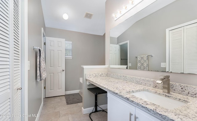 2221 Spring Creek Cir, Palm Bay, FL 32905 - bathroom with a closet, vanity, and vaulted ceiling