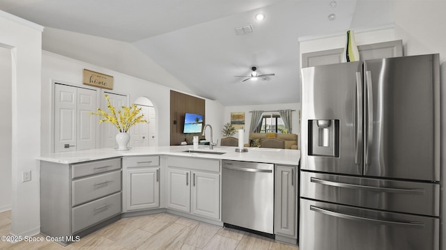 160 Eureka Ave NE, Palm Bay, FL 32907 - kitchen with stainless steel appliances, vaulted ceiling, gray cabinets, a ceiling fan, and a peninsula