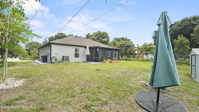 160 Eureka Ave NE, Palm Bay, FL 32907 - back of property featuring a sunroom, stucco siding, and roof with shingles