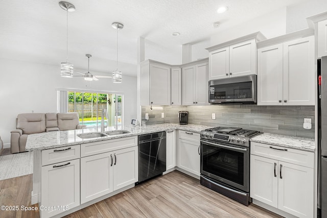 1014 Pelican Ln, Rockledge, FL 32955 - kitchen with stainless steel appliances, a peninsula, open floor plan, backsplash, and ceiling fan