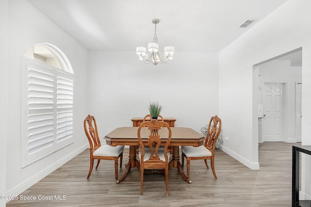 1014 Pelican Ln, Rockledge, FL 32955 - dining room with a chandelier and light wood finished floors