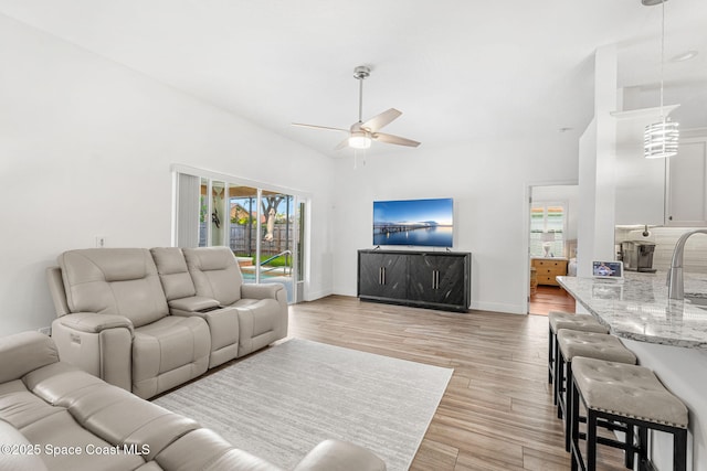 1014 Pelican Ln, Rockledge, FL 32955 - living area featuring ceiling fan, light wood-style floors, and high vaulted ceiling