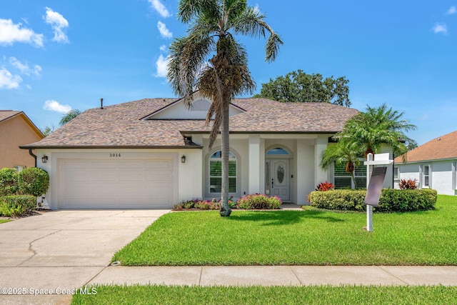 1014 Pelican Ln, Rockledge, FL 32955 - single story home with stucco siding, a garage, a front lawn, and driveway