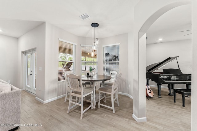 3550 Salt Marsh Cir, West Melbourne, FL 32904 - dining area featuring arched walkways and light wood-style flooring