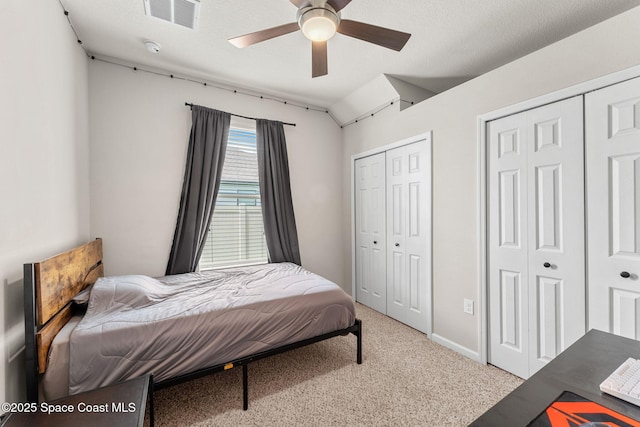 3550 Salt Marsh Cir, West Melbourne, FL 32904 - bedroom featuring two closets, light colored carpet, and a ceiling fan