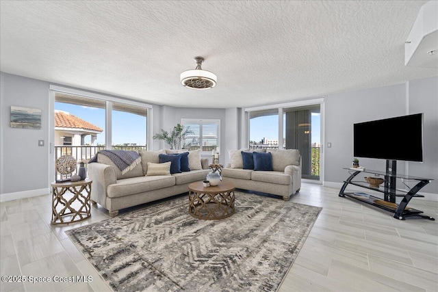 8954 Puerto Del Rio Dr Unit 1503, Cape Canaveral, FL 32920 - living room featuring a textured ceiling