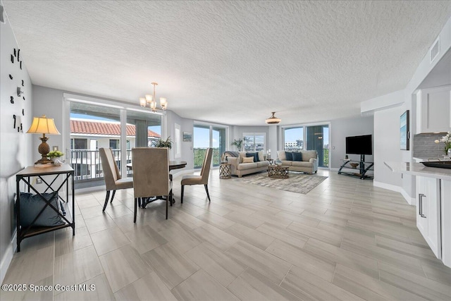 8954 Puerto Del Rio Dr Unit 1503, Cape Canaveral, FL 32920 - dining area featuring a chandelier and a textured ceiling